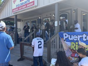 The plenazo gathering at a local Puerto Rican grocery store.