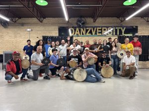 Pleneros leading the hands-on plena percussion workshop.